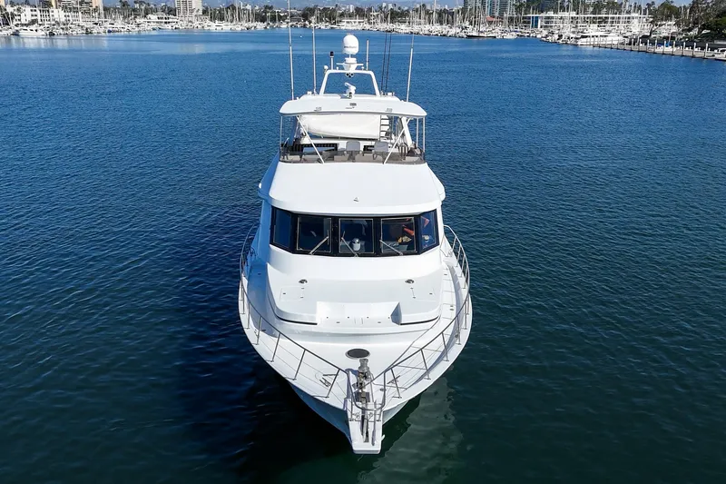Slide: The Image of A luxurious white yacht sails on calm waters with a cityscape in the background. - 9