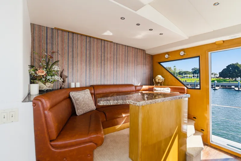 Slide: The Image of Interior of a 1990 Westport Crescent with leather seating, wooden table, and a view of the water. - 39