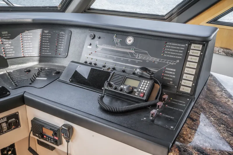 Slide: The Image of The image shows the helm of a 1990 Westport Crescent yacht with navigation and communication equipment. - 28