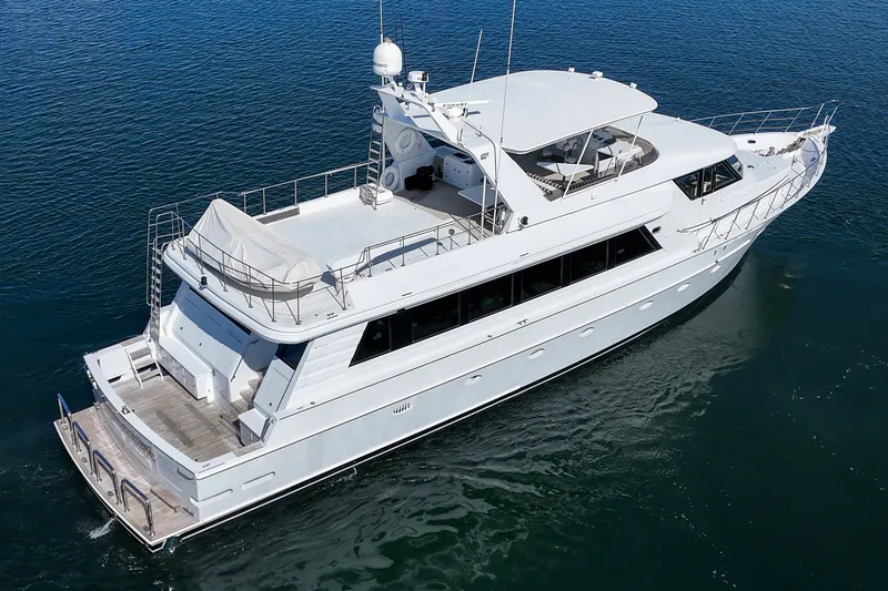 Slide: The Image of A luxurious white yacht cruising on calm waters, featuring a spacious deck and multiple levels. - 8