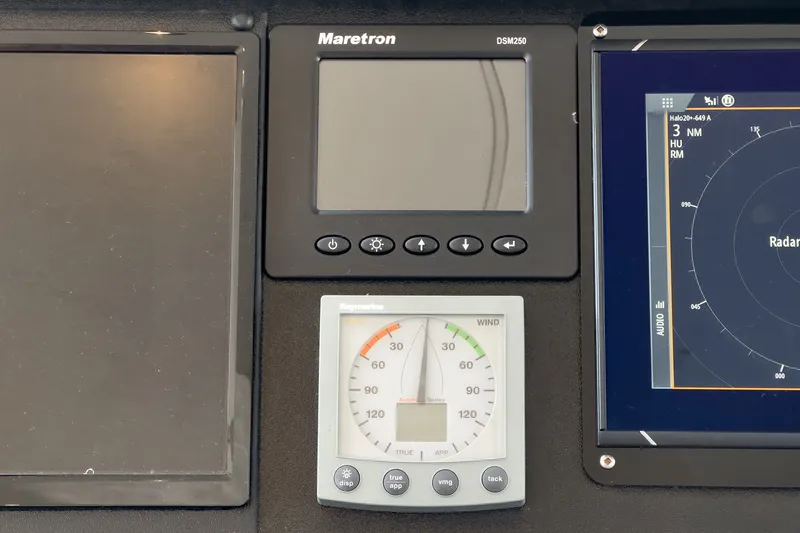 Slide: The Image of The image shows a boat instrument panel with a Maretron DSM250 display and a wind gauge. - 34