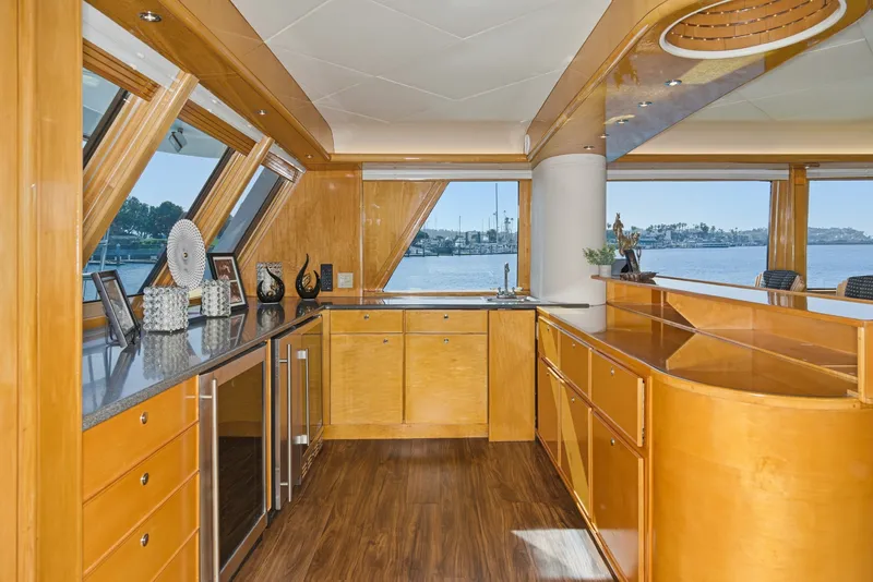 Slide: The Image of Interior of a 1990 Westport Crescent yacht with wooden cabinetry and large windows. - 17