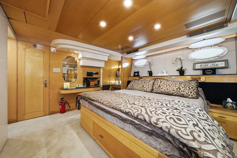 Slide: The Image of Luxurious cabin with a large bed, wooden furnishings, and elegant lighting on a Westport Crescent yacht. - 42