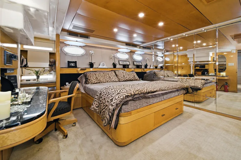 Slide: The Image of Luxurious bedroom with wood paneling, large bed, and mirrored wall on a yacht. - 40