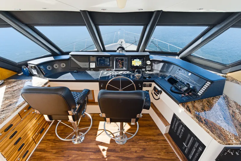 Slide: The Image of The image shows the helm of a 1990 Westport Crescent with modern navigation instruments and two cushioned seats. - 27