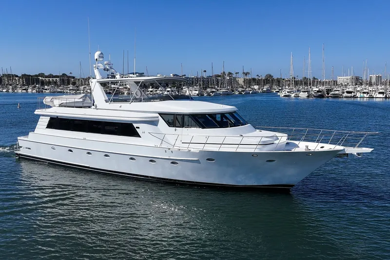 Slide: The Image of A luxurious white yacht cruising on calm waters, with a marina in the background. - 6