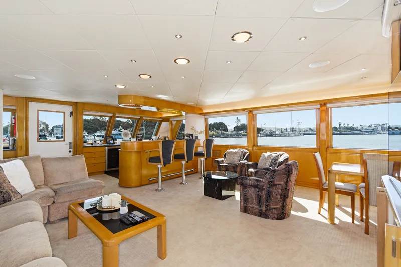 Slide: The Image of Luxurious salon with comfortable sofas, bar stools, and large windows overlooking the harbor. - 13