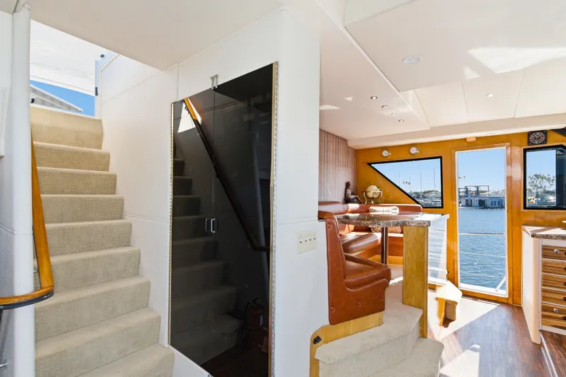 Slide: The Image of Interior of a 1990 Westport Crescent yacht with stairs, dining area, and large windows. - 38