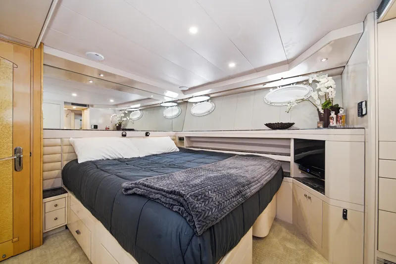 Slide: The Image of Luxurious cabin with a large bed, mirrors, and elegant lighting. - 48