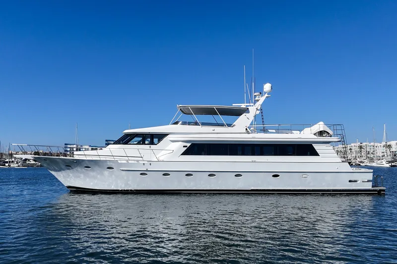 Slide: The Image of A luxurious white yacht sits calmly on the water, with a clear blue sky in the background. - 2