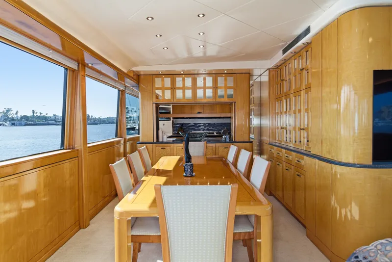 Slide: The Image of Interior of a luxury yacht featuring an elegant wooden dining area with large windows. - 19