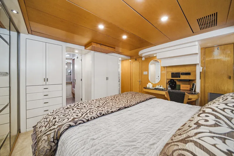 Slide: The Image of Luxurious bedroom with wood ceiling, mirrored wall, and elegant bedding on a Westport Crescent yacht. - 43