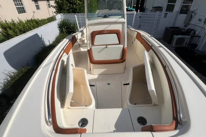 Slide: The Image of 2014 Scout 245 XSF boat interior with seating and storage compartments. - 79
