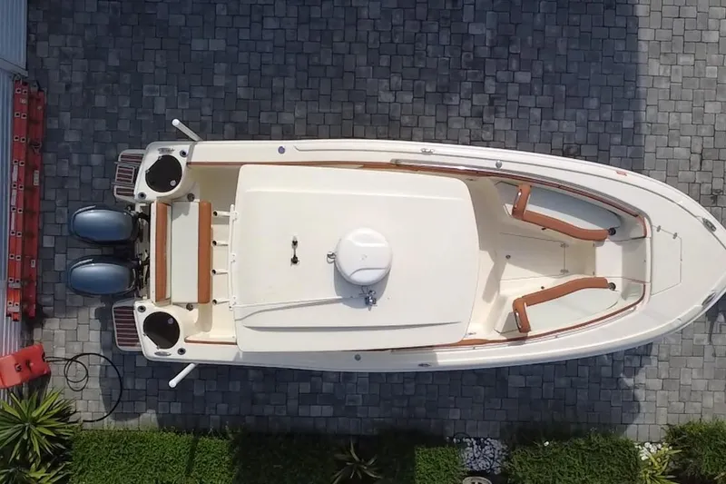 Slide: The Image of Overhead view of a 2014 Scout 245 XSF boat on a paved surface. - 8