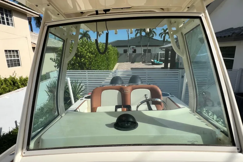 Slide: The Image of 2014 Scout 245 XSF boat interior view with steering wheel and seating. - 68