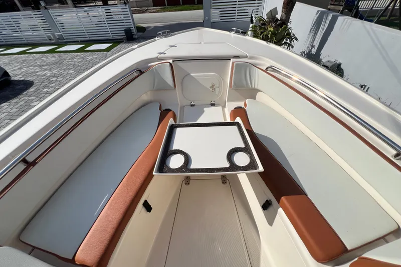 Slide: The Image of 2014 Scout 245 XSF boat interior with seating and table, showcasing modern design. - 71