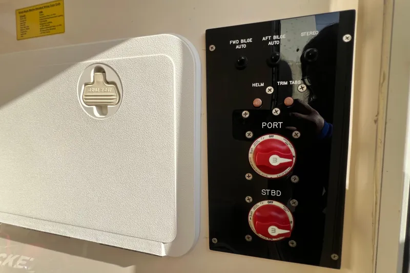 Slide: The Image of Control panel of a 2014 Scout 245 XSF boat with switches and dials. - 87