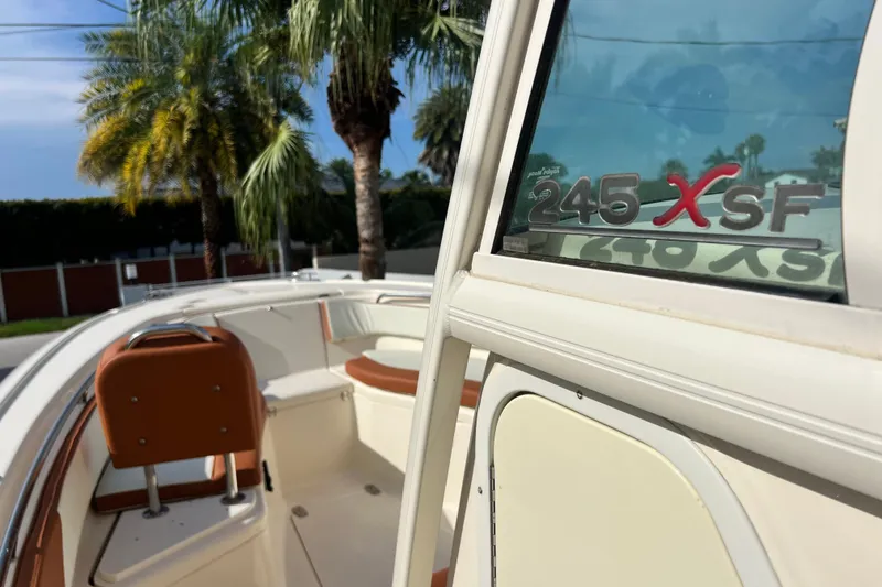 Slide: The Image of 2014 Scout 245 XSF boat interior with palm trees in the background. - 59