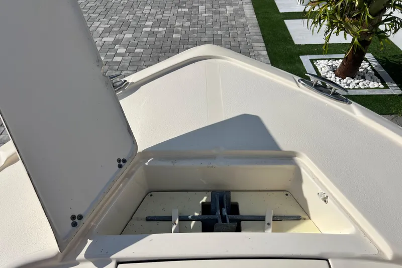 Slide: The Image of Bow view of 2014 Scout 245 XSF boat with anchor compartment open. - 73
