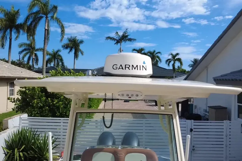 Slide: The Image of 2014 Scout 245 XSF boat with Garmin radar, palm trees in background. - 16
