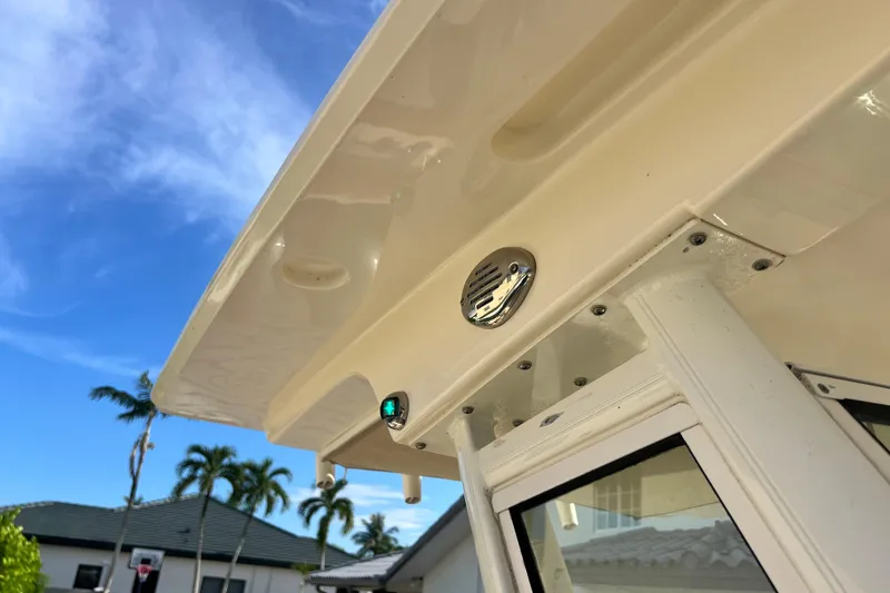 Slide: The Image of 2014 Scout 245 XSF boat detail with clear sky and palm trees in background. - 64