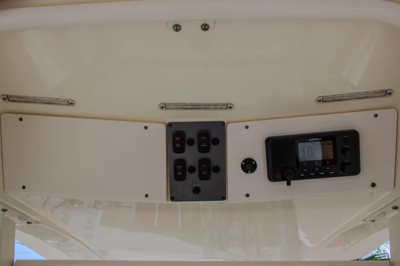 Slide: The Image of 2014 Scout 245 XSF boat dashboard with Garmin marine radio and control panel. - 20
