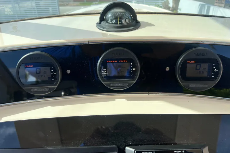 Slide: The Image of Dashboard of a 2014 Scout 245 XSF boat with Yamaha gauges and compass. - 56