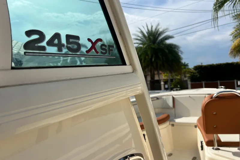 Slide: The Image of 2014 Scout 245 XSF boat with palm trees in the background. - 55