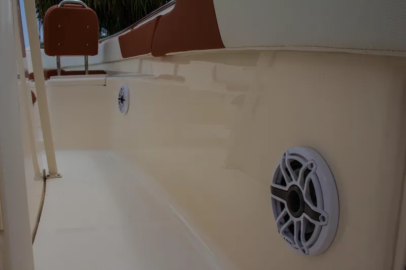 Slide: The Image of 2014 Scout 245 XSF boat interior with speakers and seating. - 19