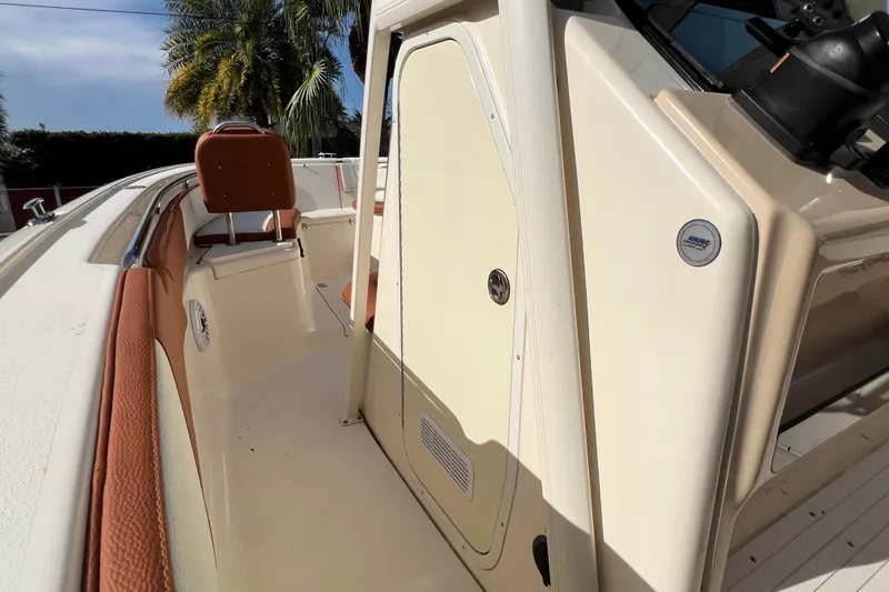 Slide: The Image of 2014 Scout 245 XSF boat interior with tan seating and sleek design. - 60
