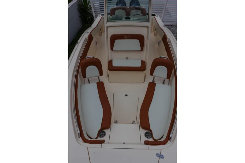 Slide: The Image of 2014 Scout 245 XSF boat interior with brown and white seating. - 9