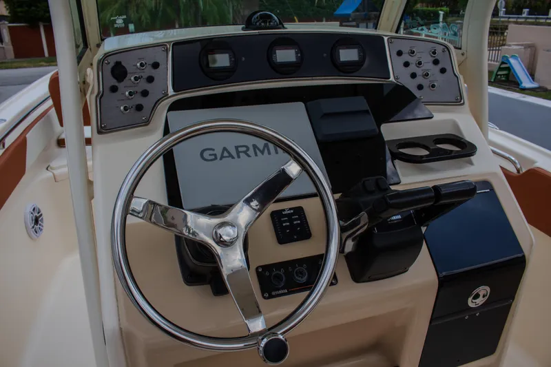Slide: The Image of 2014 Scout 245 XSF boat dashboard with Garmin navigation system and steering wheel. - 11