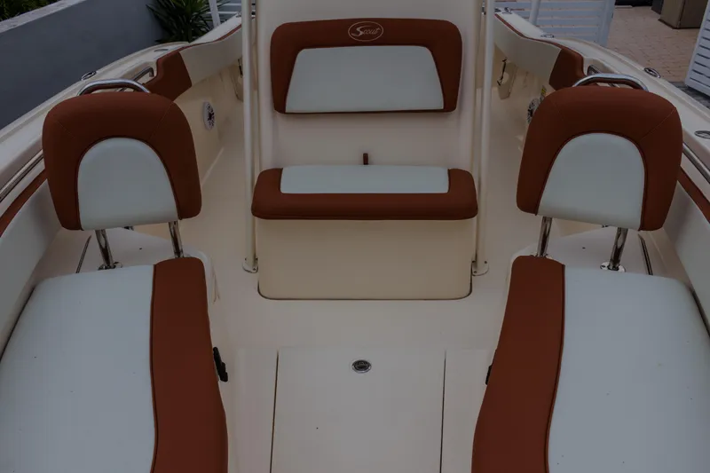 Slide: The Image of 2014 Scout 245 XSF boat interior with brown and white seating. - 3