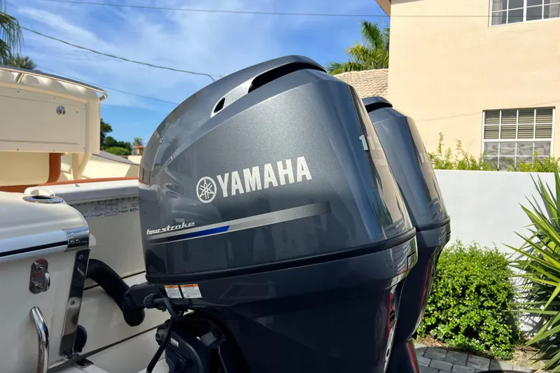 Slide: The Image of Twin Yamaha outboard motors on a 2014 Scout 245 XSF boat, sunny day backdrop. - 37