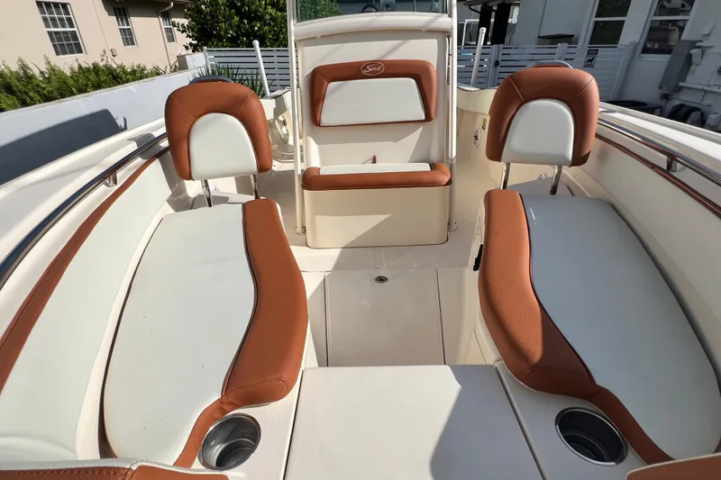 Slide: The Image of 2014 Scout 245 XSF boat interior with brown and white seating. - 74