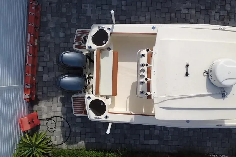 Slide: The Image of Overhead view of a 2014 Scout 245 XSF boat on a paved surface. - 9