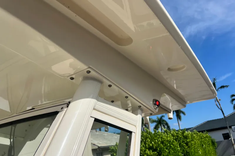 Slide: The Image of 2014 Scout 245 XSF boat canopy detail under clear blue sky. - 65