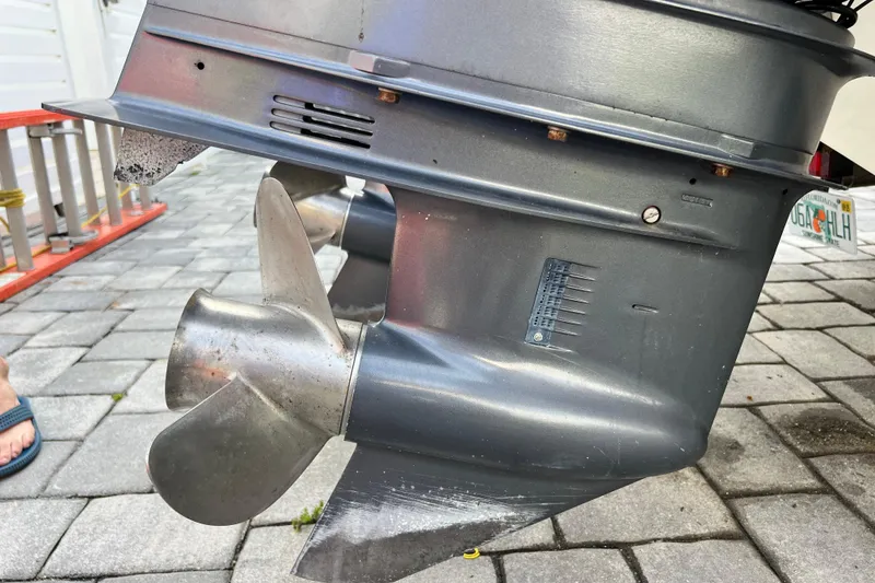 Slide: The Image of Close-up of a 2014 Scout 245 XSF boat propeller on a paved surface. - 32