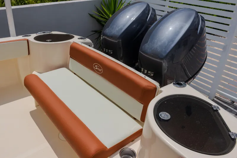 Slide: The Image of 2014 Scout 245 XSF boat interior with dual 115 engines and seating area. - 8