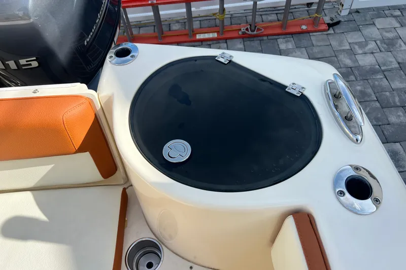 Slide: The Image of 2014 Scout 245 XSF boat interior with seating and storage compartment. - 45