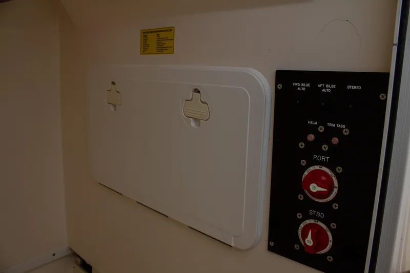 Slide: The Image of Control panel and storage compartment on a 2014 Scout 245 XSF boat. - 22