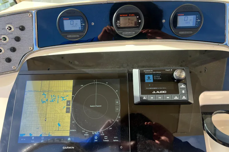 Slide: The Image of Dashboard of a 2014 Scout 245 XSF boat with Garmin navigation and JL Audio system. - 57