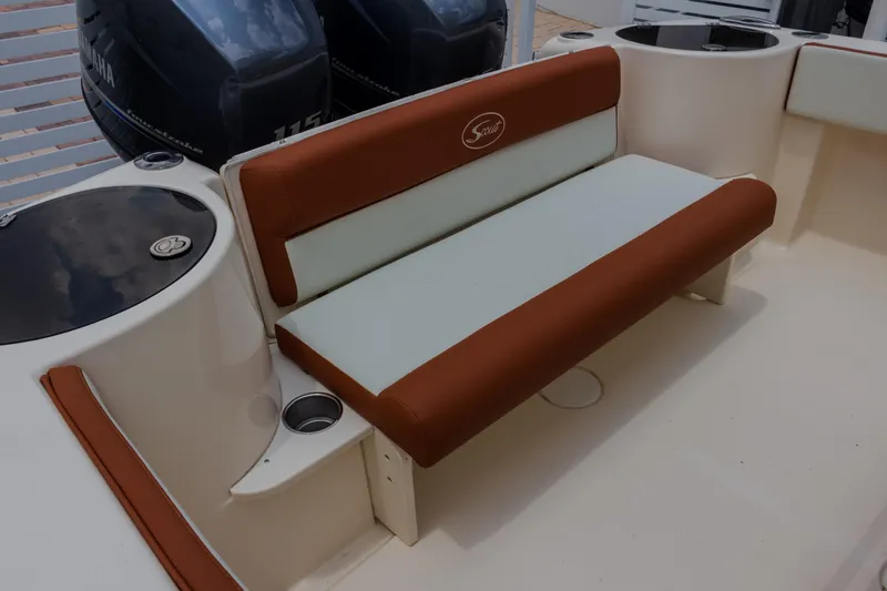 Slide: The Image of 2014 Scout 245 XSF boat seating area with brown and white upholstery. - 7