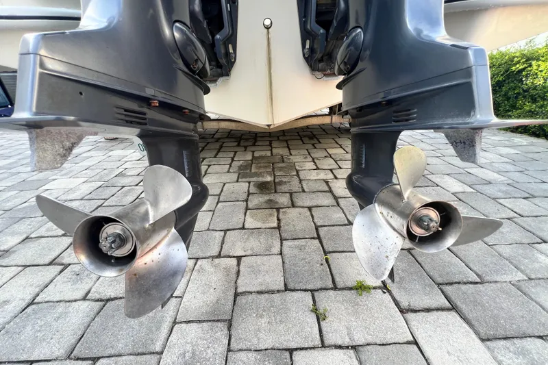 Slide: The Image of Twin propellers of a 2014 Scout 245 XSF boat on a paved surface. - 35