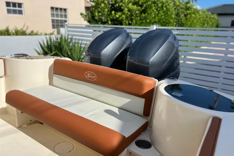 Slide: The Image of 2014 Scout 245 XSF boat interior with dual engines and cushioned seating. - 44