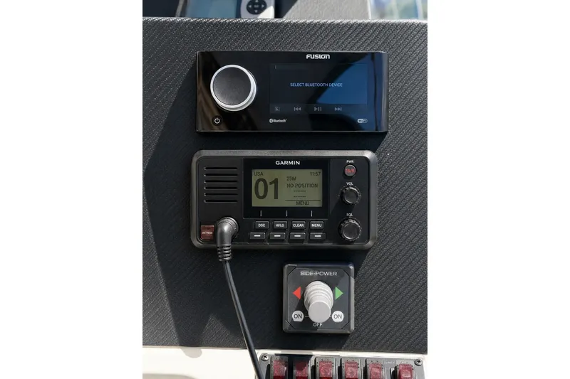 Slide: The Image of Control panel with Fusion stereo, Garmin radio, and Side-Power joystick on 2005 Compton 33 Downeast Express. - 9