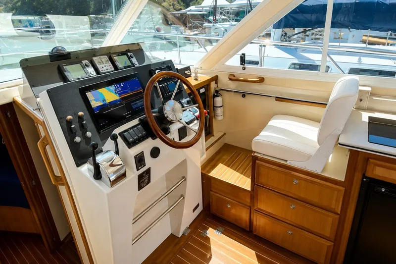 Slide: The Image of 2005 Compton 33 Downeast Express helm with navigation equipment and wooden accents. - 12