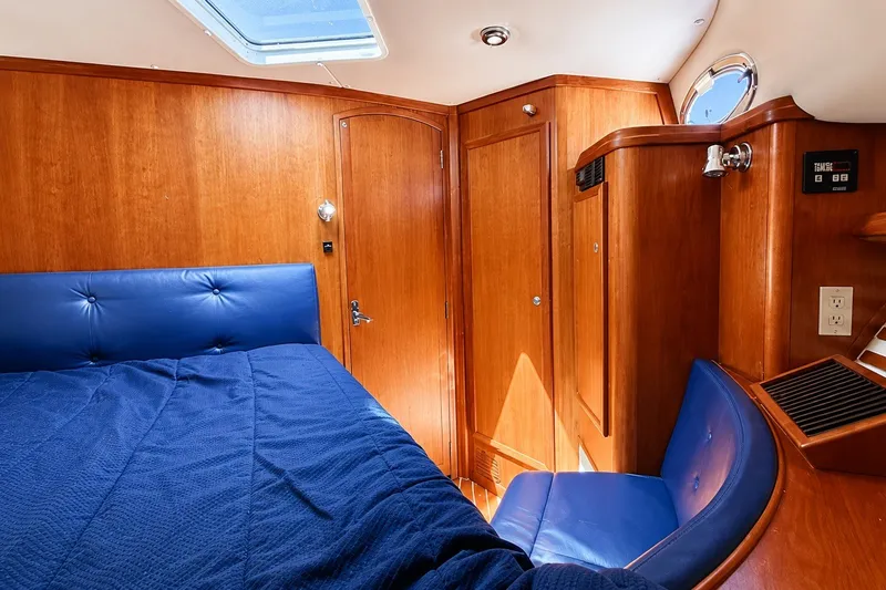 Slide: The Image of Luxurious cabin interior of 2005 Compton 33 Downeast Express with wood paneling and blue upholstery. - 17