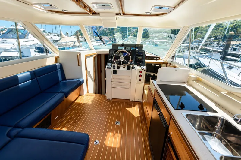 Slide: The Image of Interior of 2005 Compton 33 Downeast Express yacht with helm, seating, and kitchenette. - 14