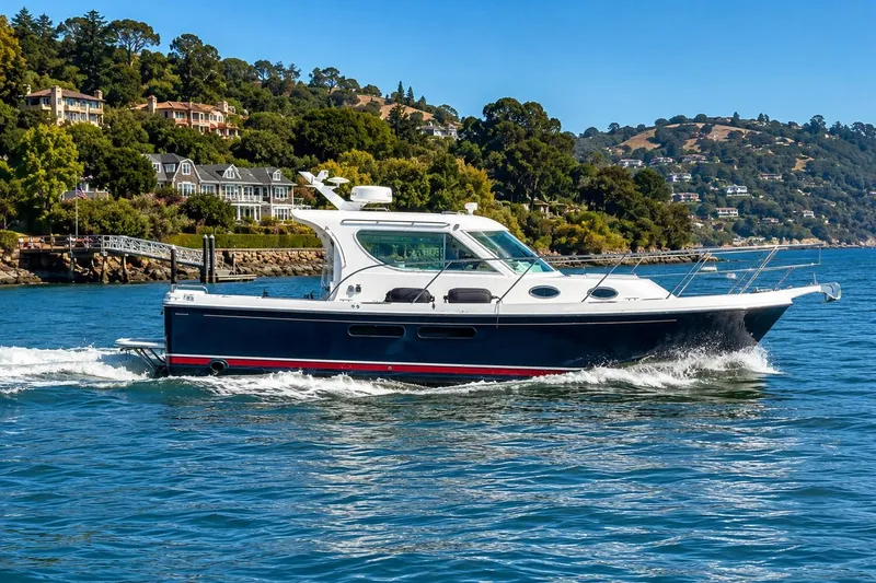 Slide: The Image of 2005 Compton 33 Downeast Express cruising on scenic coastal waters. - 3